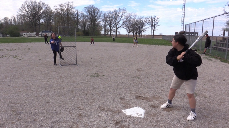 Kettle and Stony Point Chief Kimberly Bressette throws a pitch to Sunday George at the baseball diamond on Lake Road in Kettle Point First Nation on May 1, 2024. The facility has been awarded $90,000 in upgrades by the Jays Care Foundation. (Brent Lale/CTV News London)