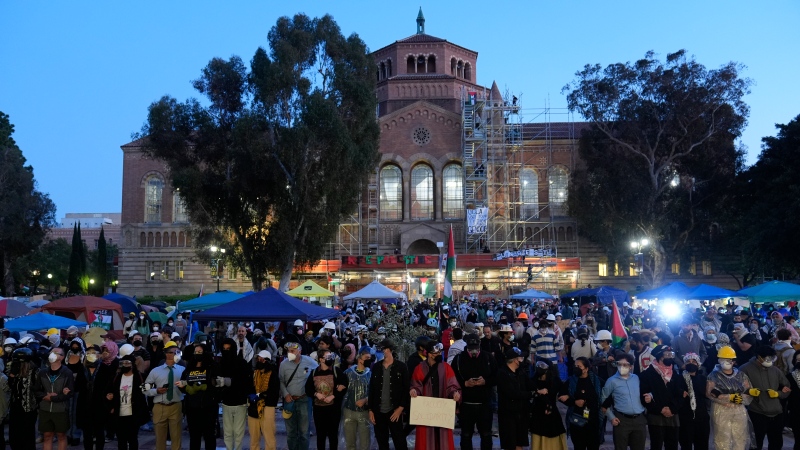 Pro-Palestinian demonstrators lock arms on the UCLA campus, May 1, 2024, in Los Angeles. (AP Photo/Jae C. Hong)