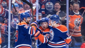 Edmonton Oilers' Leon Draisaitl (29), Ryan Nugent-Hopkins (93) and Zach Hyman (18) celebrate a goal against the Los Angeles Kings during second period NHL playoff action in Edmonton on Wednesday May 1, 2024. (Jason Franson / The Canadian Press) 