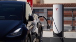 A Tesla charging station in a parking lot in Santa Monica, California, is pictured here in September 2022. Tesla has abruptly fired the team running its electric vehicle charging business. (Allison Dinner / Getty Images via CNN Newsource)