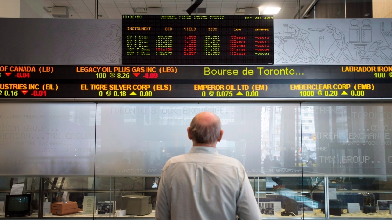 A man watches the financial numbers on the digital ticker tape at the TMX Group in Toronto's financial district, Friday, May 9, 2014. THE CANADIAN PRESS/Darren Calabrese