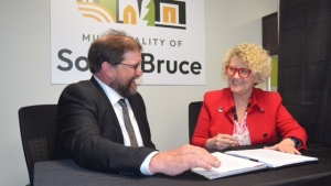 South Bruce Mayor Mark Goetz, and Nuclear Waste Management Organization President Laurie Swami sign a hosting agreement. May 1, 2024. (Scott Miller/CTV News London)