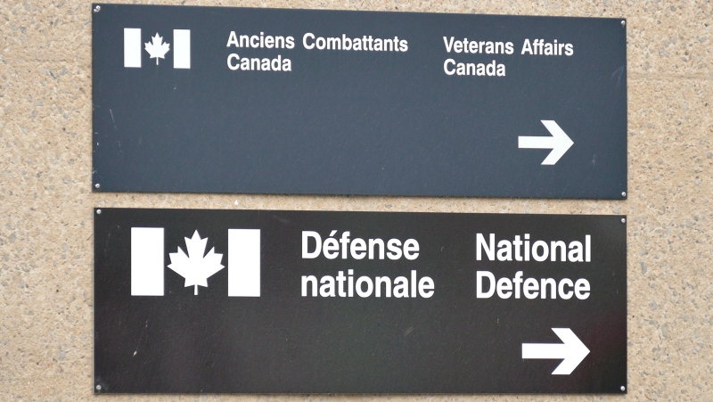 Signs for a National Defence and Veterans affairs office is pictured in St-Jean-sur-Richelieu on Monday Oct. 20, 2014. (Pascal Marchand/The Canadian Press)