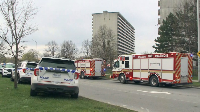 Emergency vehicles are seen outside Overbrook apartment building where an earlier morning fire sent two children and a woman to hospital in critical condition Thursday, May 2, 2024. The Ottawa Police Arson Unit says the fire has been deemed suspicious.