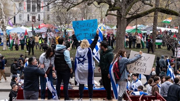 Pro-Israel demonstrators protest outside a pro-Palestinian encampment set up on McGill University's campus, in Montreal, Thursday, May 2, 2024. (Christinne Muschi, The Canadian Press)
