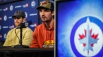 Winnipeg Jets’ Adam Lowry, left, and goaltender Connor Hellebuyck speak to media during post playoff press conference in Winnipeg