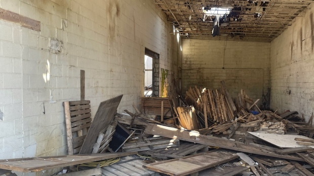 Wooden pallets and debris inside the former St. Pierre Renovation Centre as seen from outside the building on May 2, 2024. (Daryl Newcombe/CTV News London)