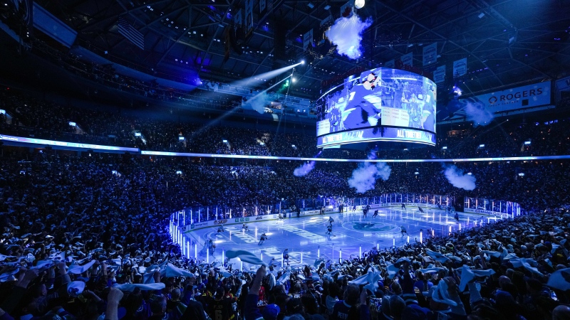 Fans wave towels as the Vancouver Canucks and Nashville Predators skate onto the ice before Game 5 of an NHL hockey Stanley Cup first-round playoff series, in Vancouver, on Tuesday, April 30, 2024. THE CANADIAN PRESS/Darryl Dyck