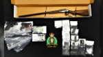 A handout photo from New Brunswick RCMP shows drugs and firearms seized from a home in Moncton, N.B.