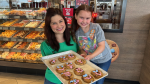 Sarah Freemark (L) and her decorating partner, Alyson Williams (R), volunteering in the Tim Hortons Smile Cookie campaign at the Tim Horton's in Innisfil, Ont. on May, 3, 2024. (CTVNews/RobCooper)