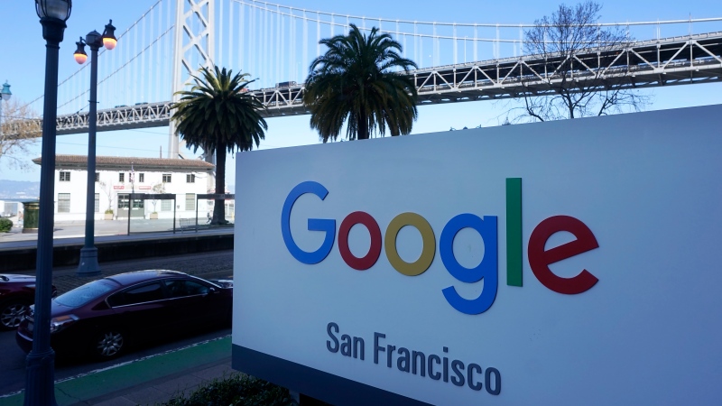The San Francisco-Oakland Bay Bridge is seen behind a Google sign at the company's office in San Francisco, April 12, 2023. (Jeff Chiu / AP Photo, File )