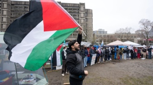 Pro-Palestinian supporters surround a protest encampment set up on the McGill University campus, in Montreal, Thursday, May 2, 2024. (Ryan Remiorz, The Canadian Press)
