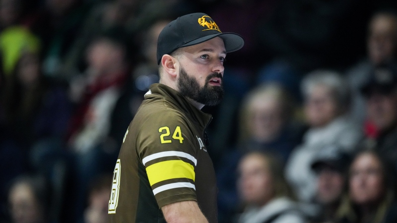 Manitoba-Carruthers third Reid Carruthers watches his shot while playing Team Manitoba-Dunstone during the playoffs at the Brier, in Regina, on Friday, March 8, 2024.(Darryl Dyck/The Canadian Press)