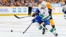 Vancouver Canucks center Pius Suter (24) passes the puck past Nashville Predators center Colton Sissons (10) during the first period in Game 6 of an NHL hockey Stanley Cup first-round playoff series Friday, May 3, 2024, in Nashville, Tenn. (AP Photo/George Walker IV)