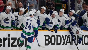 Vancouver Canucks center Pius Suter (24) celebrates his goal against the Nashville Predators with teammates during the third period in Game 6 of an NHL hockey Stanley Cup first-round playoff series Friday, May 3, 2024, in Nashville, Tenn. (AP Photo/George Walker IV)