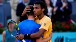 Felix Auger-Aliassime, of Canada, embraces Jiri Lehecka, of the Czech Republic, after a semi-final match at the Mutua Madrid Open tennis tournament in Madrid, Spain, Friday, May 3, 2024. (Bernat Armangue, The Canadian Press)
