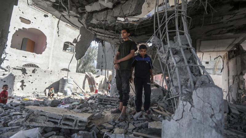 Palestinians stand in the ruins of the Chahine family home, after an overnight Israeli strike that killed at least two adults and five boys and girls under the age of 16 in Rafah, southern Gaza Strip, Friday, May 3, 2024. An Israeli strike on the city of Rafah on the southern edge of the Gaza Strip killed several people, including children, hospital officials said Friday. (AP / Ismael Abu Dayyah)