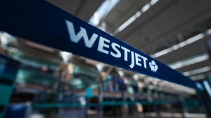 A WestJet logo is seen in the domestic check-in area at Vancouver International Airport, in Richmond, B.C., on Friday, May 19, 2023. (THE CANADIAN PRESS/Darryl Dyck)