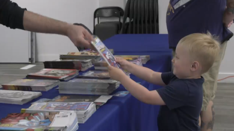 Three-year-old Jude accepts a free comic book at The Hero's Tale in Cambridge on May 4, 2024. (Shelby Knox/CTV News)