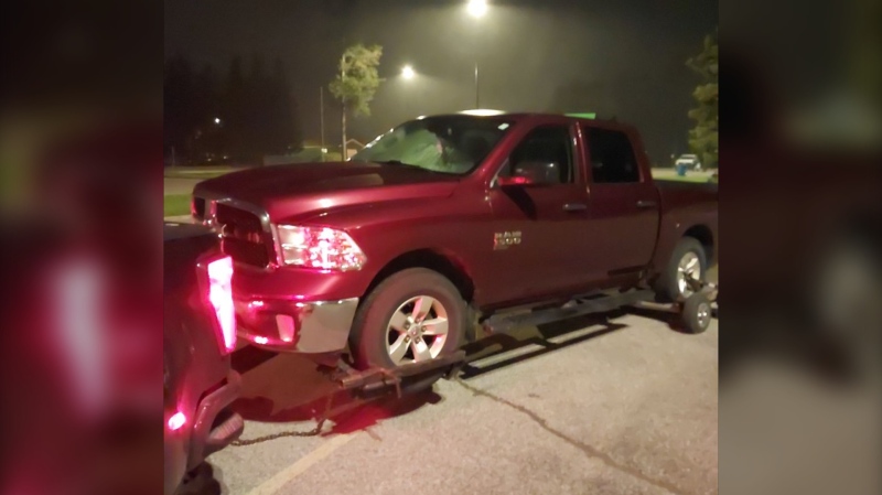 A red pickup truck getting towed (Source: OPP Highway Safety Division/X)
