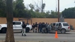 In this image made from video, Mexican security forces frisk men at a checkpoint in Ensenada, Mexico, Thursday, May 2, 2024. Mexican authorities said Thursday they have found tents and questioned a few people in the case of two Australians and an American who went missing over the weekend in the Pacific coast state of Baja California. (AP Photo)
