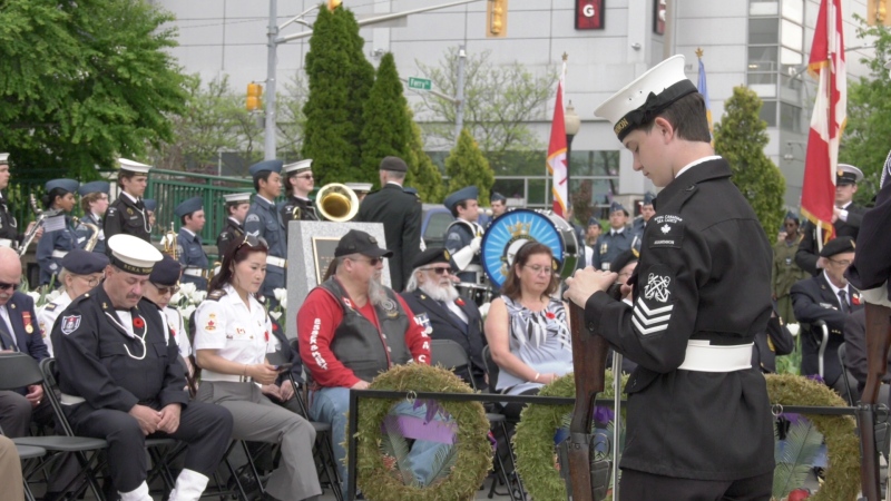 A member of the Royal Canadian Sea Cadets, right, stands in silence at the annual Battle of the Atlantic commemorative ceremony in Windsor on May 5, 2024. (Sanjay Maru/CTV News Windsor)