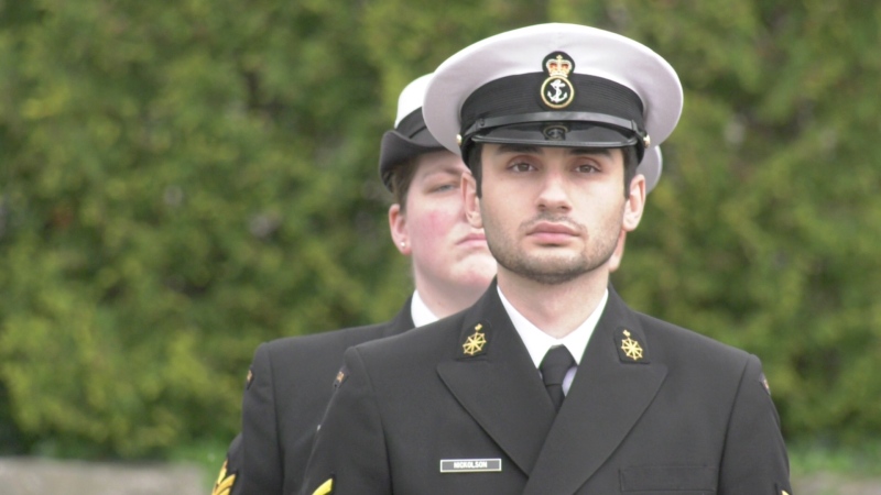 A member of the Royal Canadian Sea Cadets, right, stands in silence at the annual Battle of the Atlantic commemorative ceremony in Windsor on May 5, 2024. (Sanjay Maru/CTV News Windsor)
