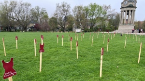 Cut outs of red clothing are displayed on the lawn of Victoria Park in Kitchener, each baring the name of a murdered or missing Indigenous person. May 5, 2024. (Hannah Schmidt)