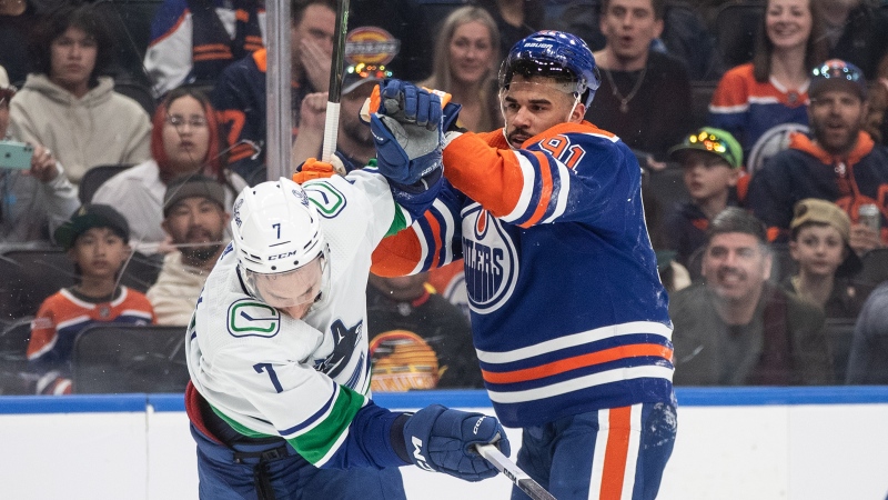 Vancouver Canucks' Carson Soucy (7) and Edmonton Oilers' Evander Kane (91) rough it up during second period NHL action in Edmonton, Saturday, April 13, 2024. THE CANADIAN PRESS/Jason Franson