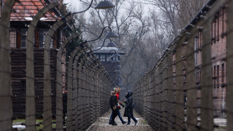 People visit the former Nazi concentration and extermination camp Auschwitz-Birkenau in Oswiecim, Poland, Thursday, Jan. 26, 2023. (AP Photo/Michal Dyjuk)