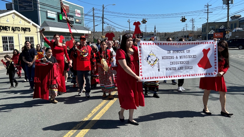 A group is pictured walking down George Street in Sydney, N.S., on Sunday as part of Red Dress Day – a day to raise awareness about missing and murdered Indigenous women and girls. 