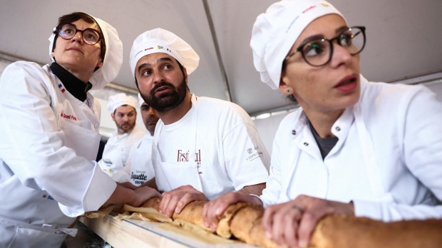 Eighteen French bakers took part in beating the world record for the longest baguette during the Suresnes Baguette Show in Suresnes, France, on Sunday. (Stephanie Lecocq/Reuters via CNN Newsource)
