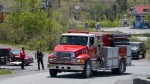 Firefighters arrive at a command centre within an evacuated zone while battling a wildfire outside of Halifax on Wednesday, May 31, 2023. THE CANADIAN PRESS/Darren Calabrese