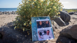 The photos of the foreign surfers who disappeared are placed on the beach in Ensenada, Mexico, Sunday, May 5, 2024. (AP Photo/Karen Castaneda)