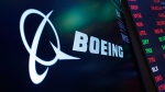 The logo for Boeing appears on a screen above a trading post on the floor of the New York Stock Exchange, July 13, 2021. (AP Photo/Richard Drew, file)
