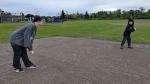 Siblings Ella Pringle and Aidan Ridley play baseball at a park in a handout photo as part of their parents' "conscious" effort to get them out of the house and away from their screens for regular exercise as recommended in a ParticipAction report. THE CANADIAN PRESS/HO
