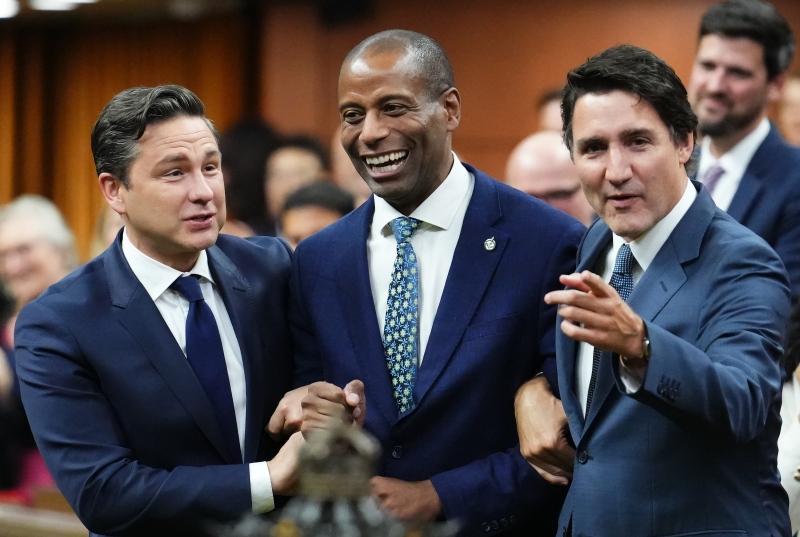 File photo of newly-elected Speaker of the House of Commons Greg Fergus is escorted into the House of Commons by Prime Minister Justin Trudeau and Conservative Leader Pierre Poilievre on Parliament Hill on Oct. 3, 2023 (Sean Kilpatrick / THE CANADIAN PRESS)