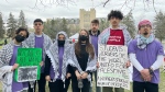 Several Pro-Palestinian protesters pose for a photo at an encampment at the University of Manitoba on May 7, 2024. (Alexandra Holyk/CTV News Winnipeg)