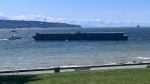 This photo shows a barge drifting toward a Vancouver beach on May 7, 2024. (Credot: Twitter/@vancity_el) 