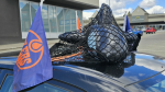 An inflatable orca, representing the Vancouver Canucks, trapped in netting on top of Edmonton Oilers fan Jeannine McDonald's car in Prince George, B.C. (Supplied)