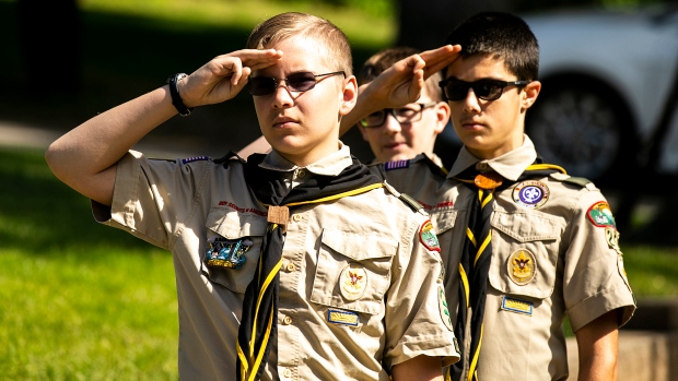 Boy Scouts salute as the national anthem is performed during a Memorial Day ceremony, Monday, May 29, 2023, at Oakland Cemetery in Iowa City, Iowa. (Joseph Cress/Iowa City Press-Citizen via AP) 