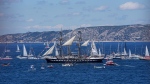 The Belem, the three-masted sailing ship bringing the Olympic flame from Greece, is escorted by other boats when approaching Marseille, southern France, Wednesday, May 8, 2024. (AP Photo/Laurent Cipriani) 