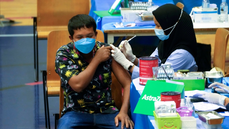 A health worker administers a dose of the AstraZeneca COVID-19 vaccine to a man in Bangkok on Feb. 23, 2022. (Sakchai Lalit / AP Photo) 