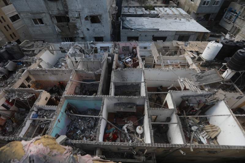 Palestinians look at the destruction after an Israeli strike on residential building in Rafah, Gaza Strip, Tuesday, May 7, 2024. (Ismael Abu Dayyah / AP Photo)