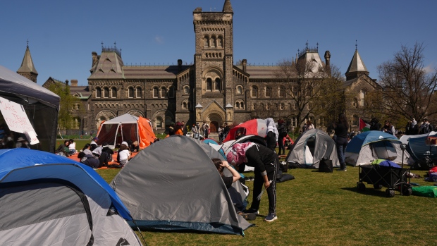 Pro-Palestinian protesters talk at an encampment set up on the University of Toronto campus on Thursday, May 2, 2024. THE CANADIAN PRESS/Chris Young