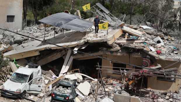 A man stands on a house that was destroyed by an Israeli airstrike, in Hanine village, south Lebanon, Thursday, April 25, 2024. Hezbollah militants and Israeli forces have been exchanging fire since a day after the Israel-Hamas war began on Oct. 7. (Mohammed Zaatari / AP Photo)