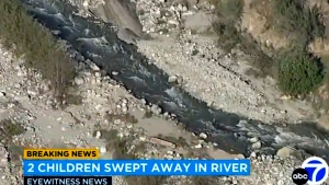 In this aerial still image provided by KABC-TV, shows a rapidly flowing creek in Southern California's San Bernardino Mountains where two young siblings died after being swept away by the rapidly flowing creek, authorities said. (KABC-TV via AP)