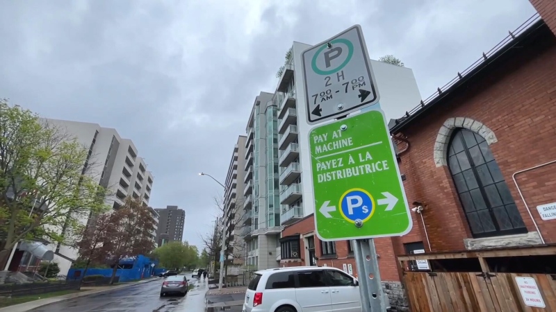 Parking signs on the side of a street in Ottawa on Wednesday, May 8, 2024. 