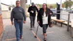 Melanie Smith walks with a cane into the courthouse in Barrie, Ont., on Wed., May 8, 2024. (CTV News/Mike Arsalides)