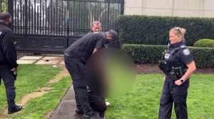 CP24 camera captures a man being handcuffed outside Drake's Toronto mansion on Wednesday, May 8, 2024. 